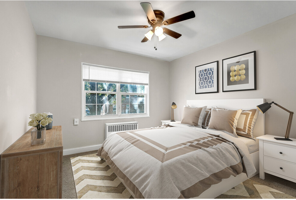 a bedroom with a large bed and a ceiling fan