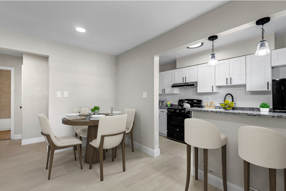 an open kitchen and dining room with a table and chairs