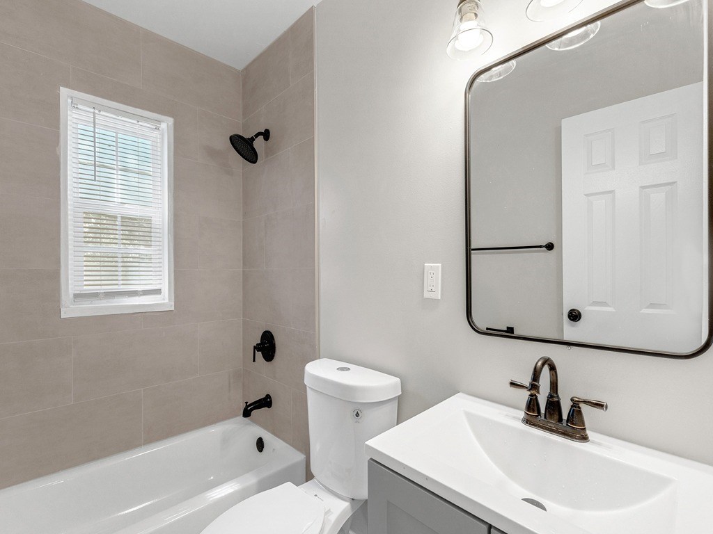 a bathroom with a sink toilet and a bath tub