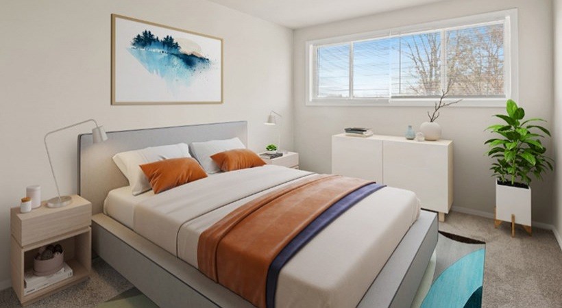 A bedroom with a large bed and a painting on the wall.