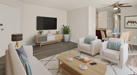 A living room with a white couch, a wooden coffee table, and a flat screen TV mounted on the wall.