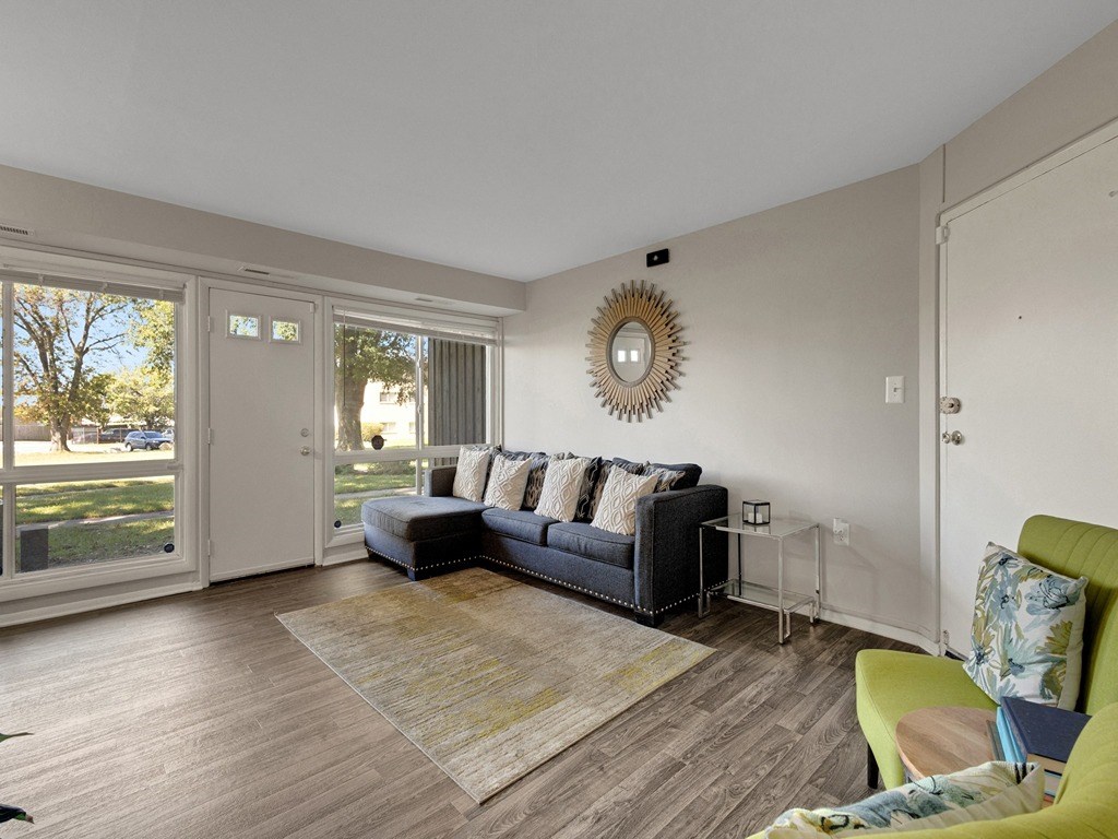 a living room with a couch and a door to a yard