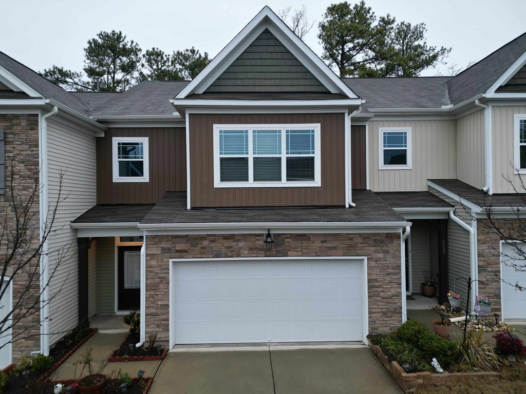 A house with a brown garage door and a white door.