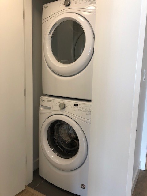 Two white front loading washing machines in a small laundry room.