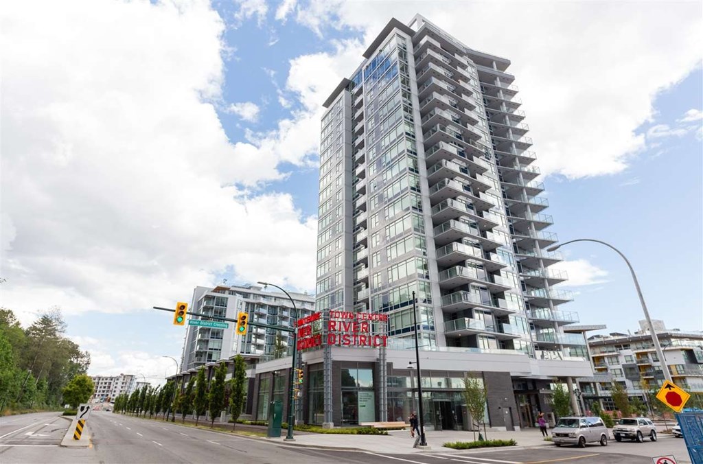 A modern building with a glass facade and a sign that reads "River District".