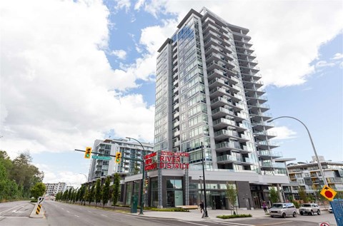A modern building with a glass facade and a sign that reads "River District".