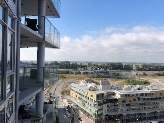 A view from a high-rise building looking out over a construction site and other buildings.