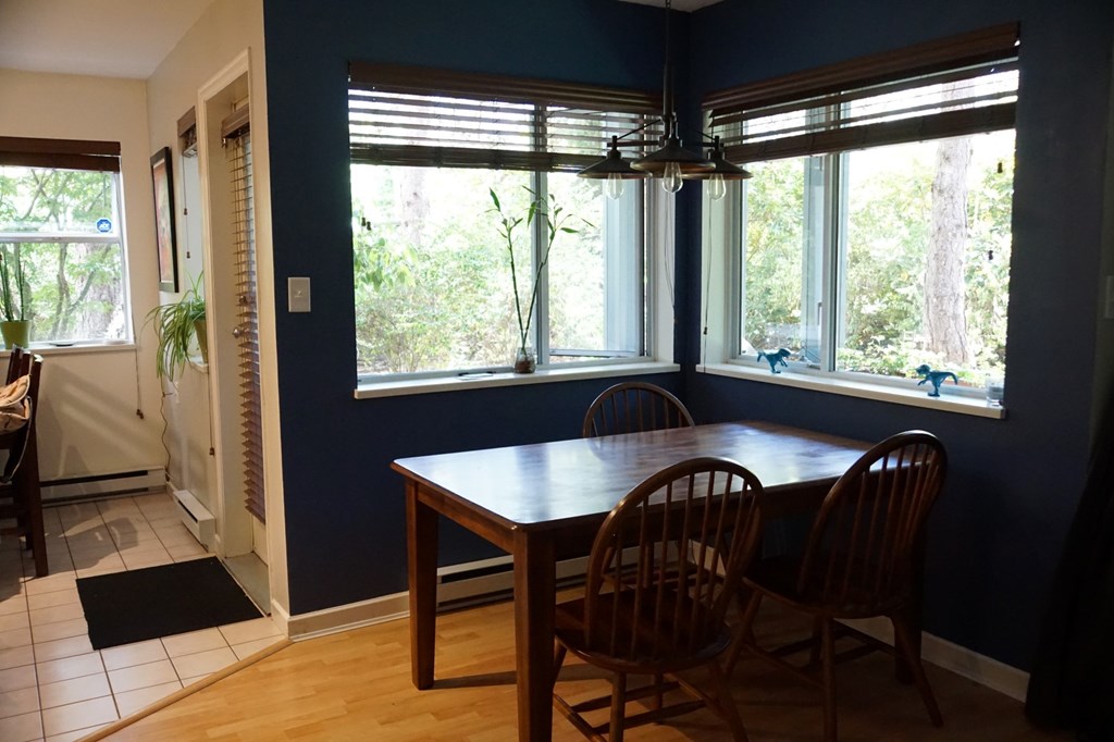 A dining room with a table and chairs.