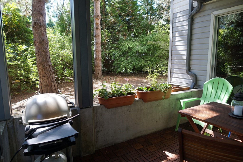 A grill is on a table outside.