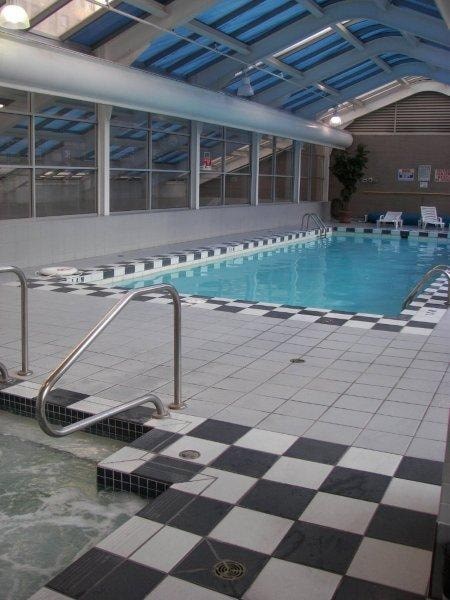 A black and white checkered tile floor in a swimming pool.