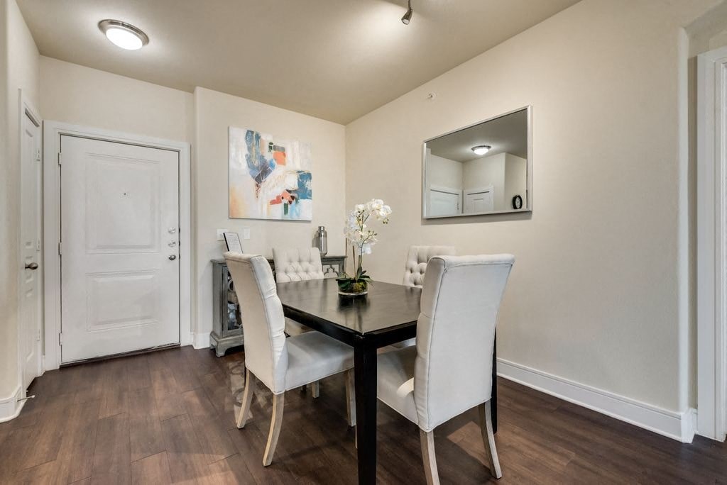 a dining room with a table and chairs