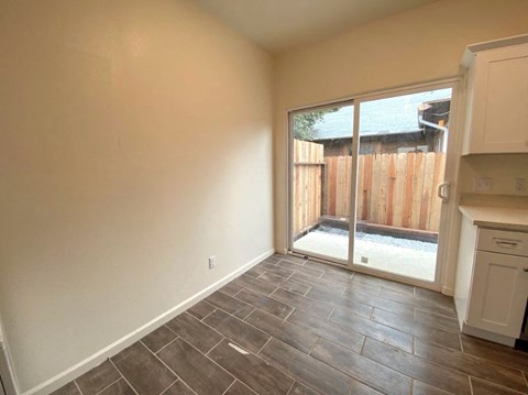 a living room with a sliding glass door to a patio