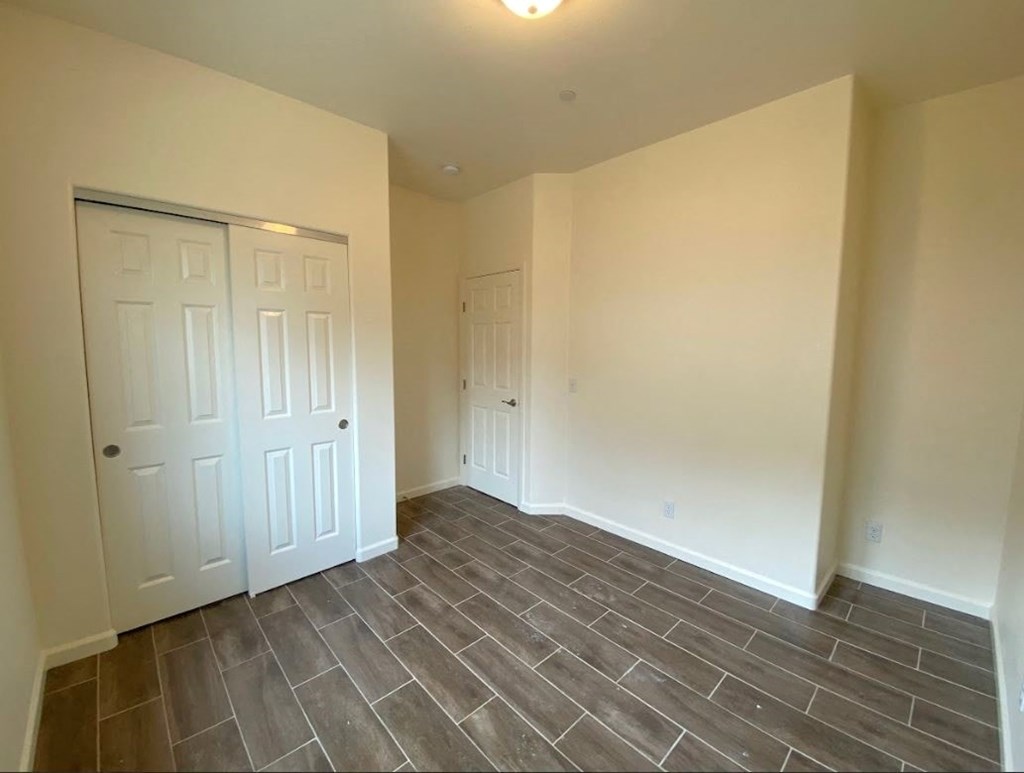 a empty room with tile floor and white doors