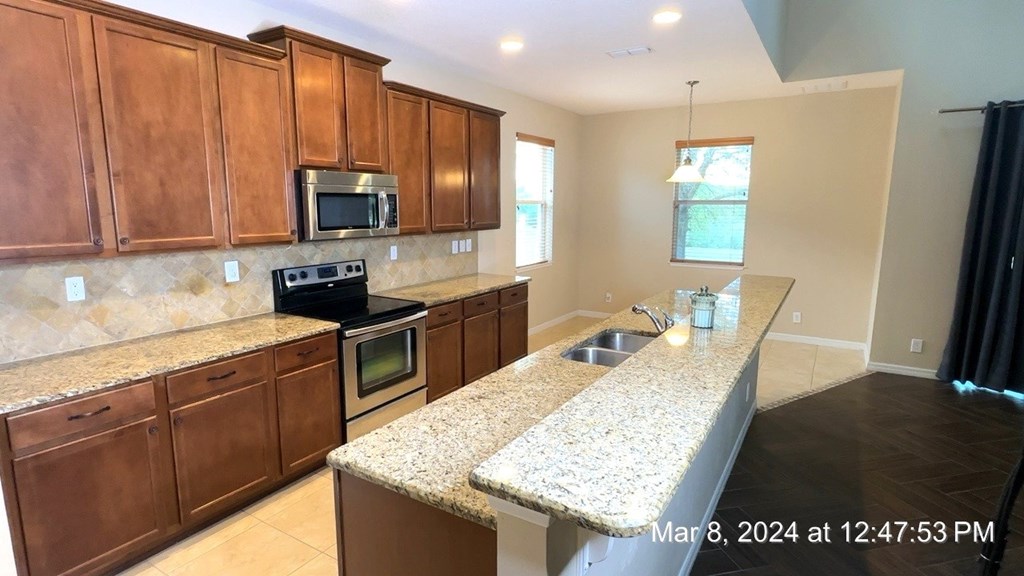 a kitchen with wooden cabinets and granite counter tops