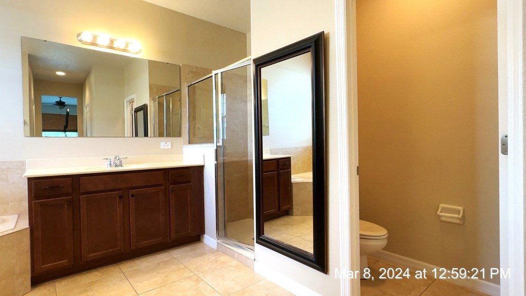 a bathroom with a shower and a sink and a mirror