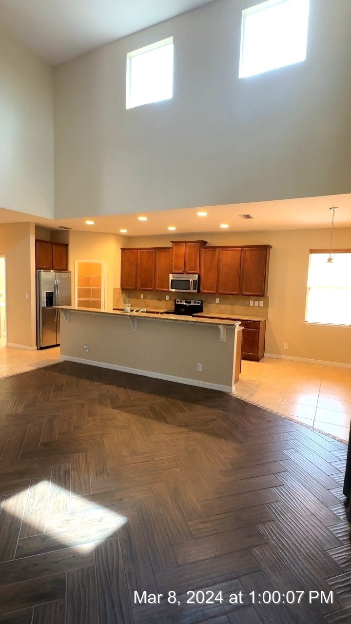 an empty kitchen with a counter in the middle of it