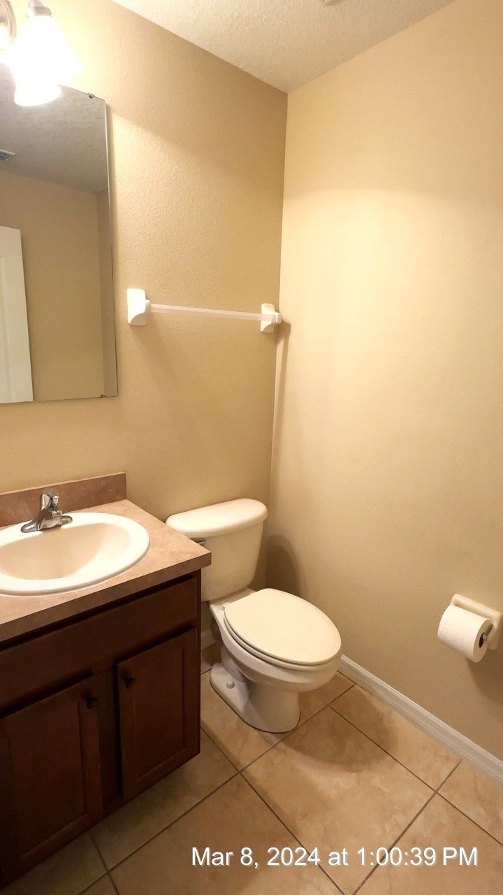 a bathroom with a toilet and a sink and a mirror