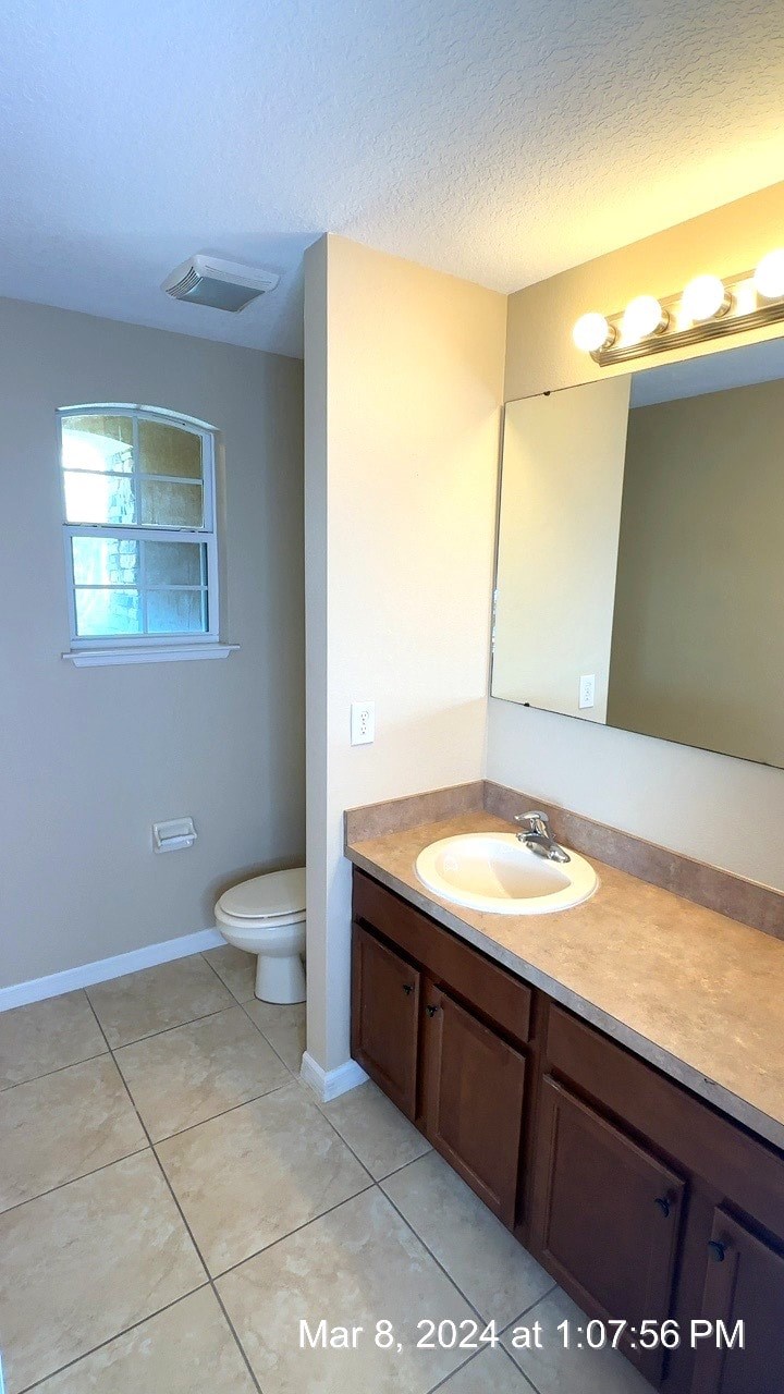 a bathroom with a sink and a toilet and a mirror