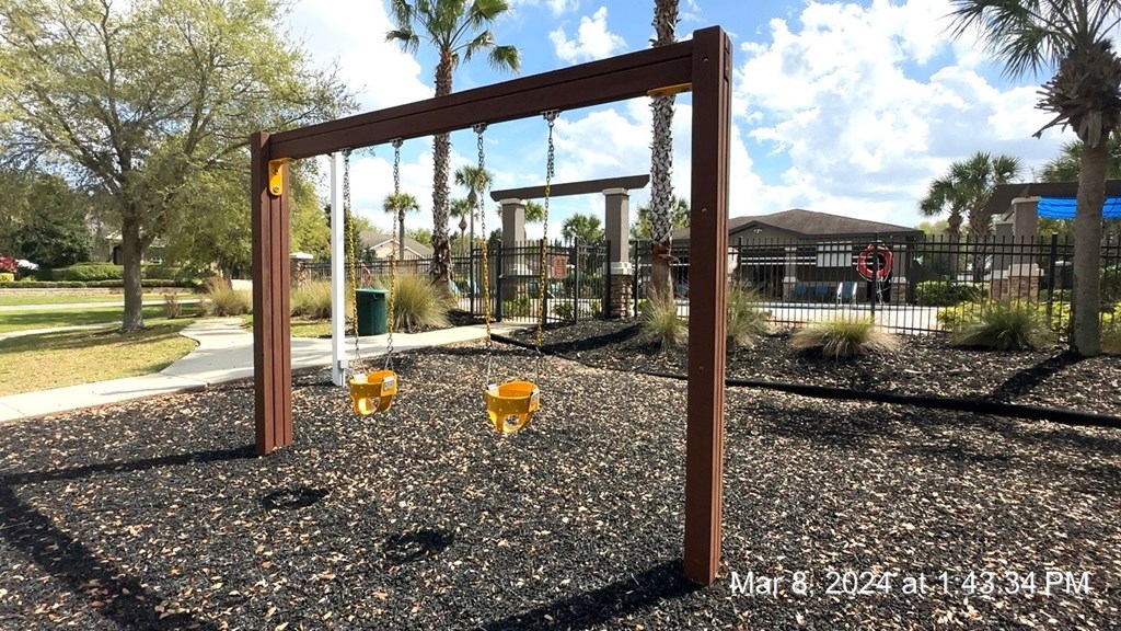 a swing set in a park with swings and monkey bars