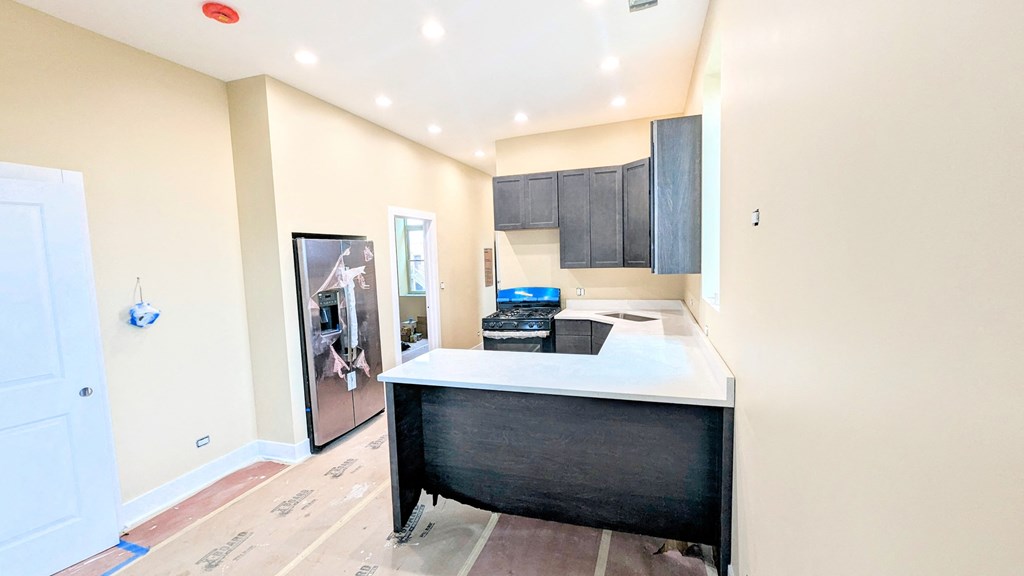 a kitchen with a counter top and a refrigerator