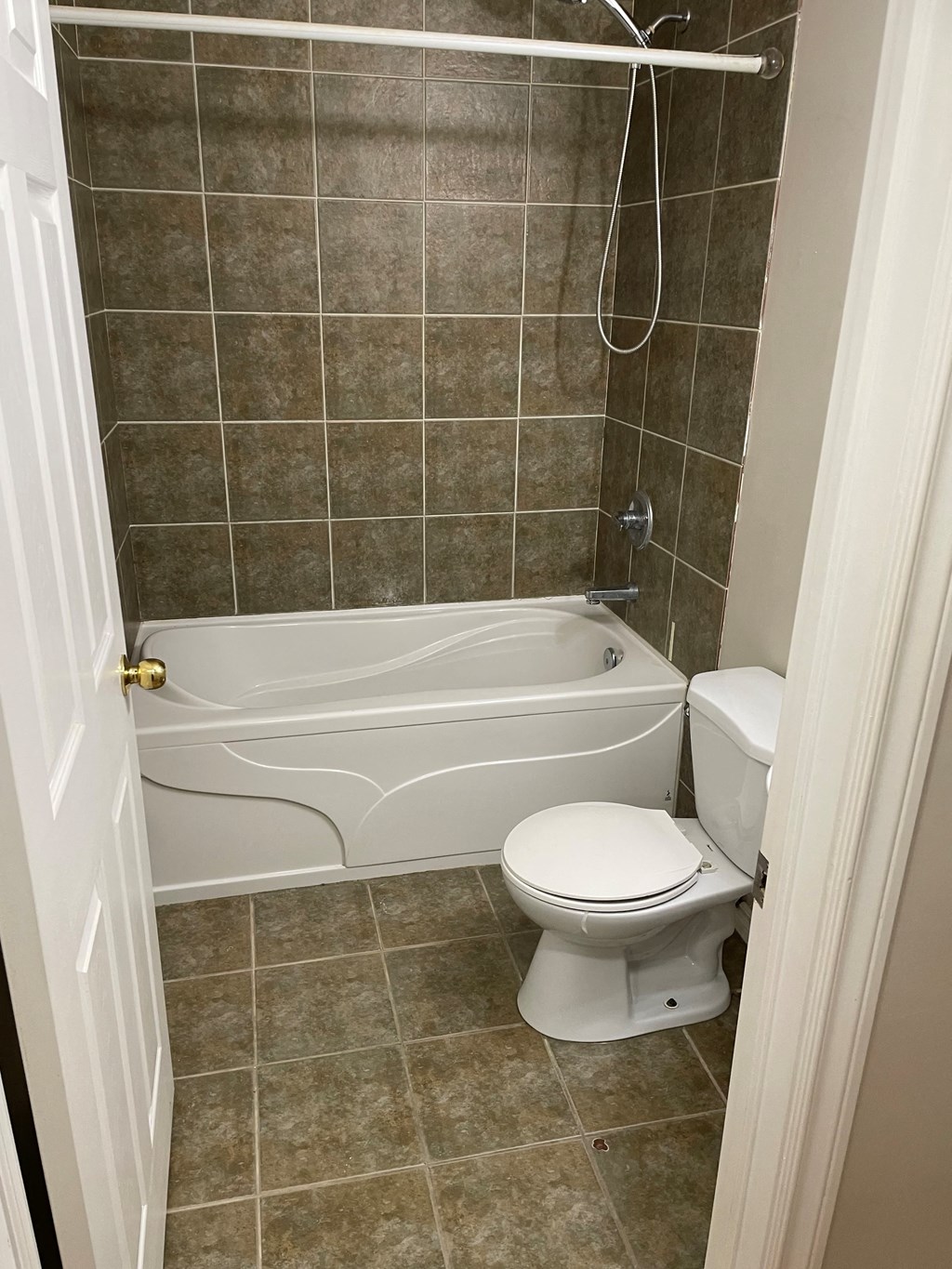 a small bathroom with a toilet and a bath tub