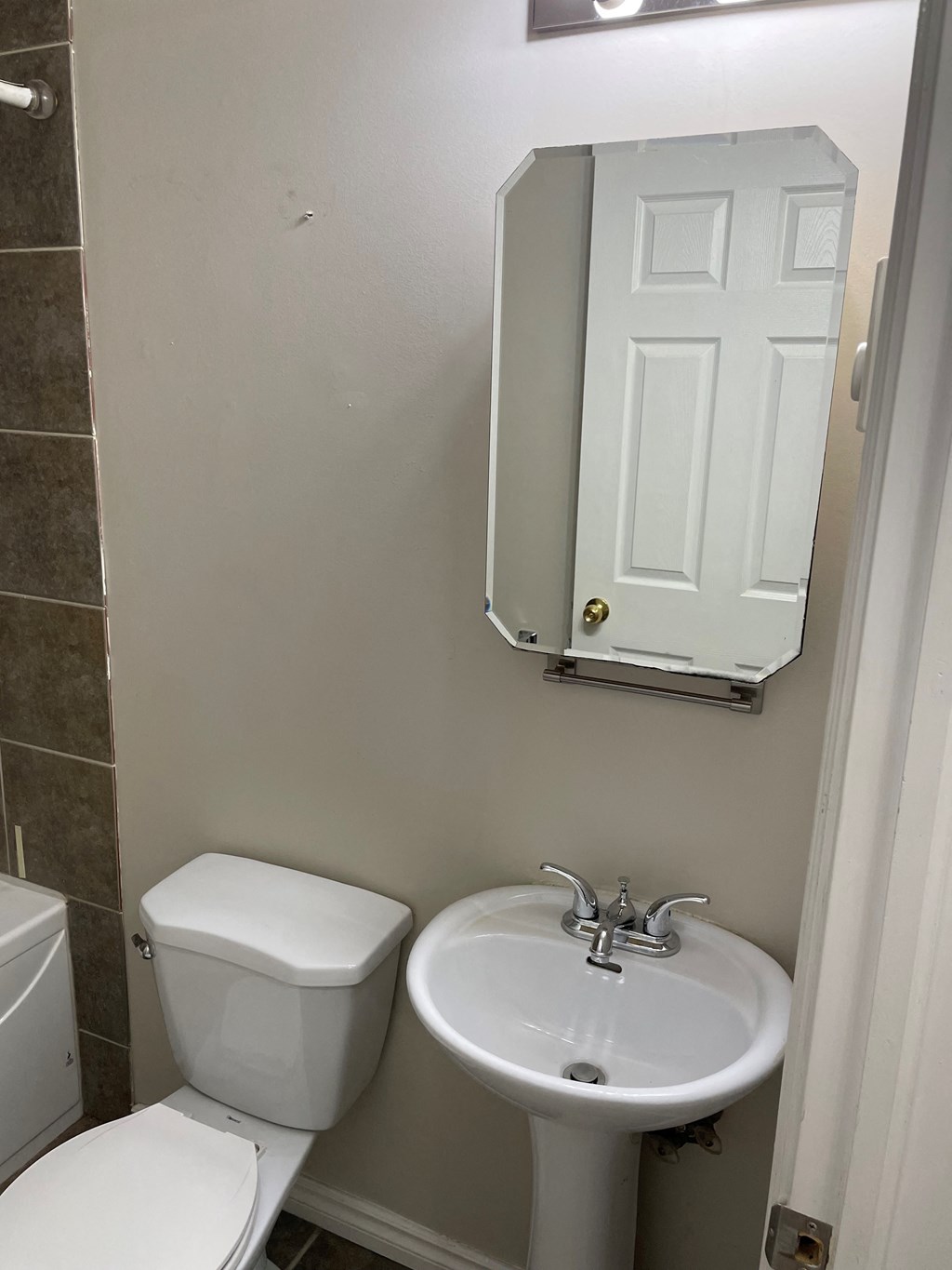 a small bathroom with a sink toilet and a cabinet