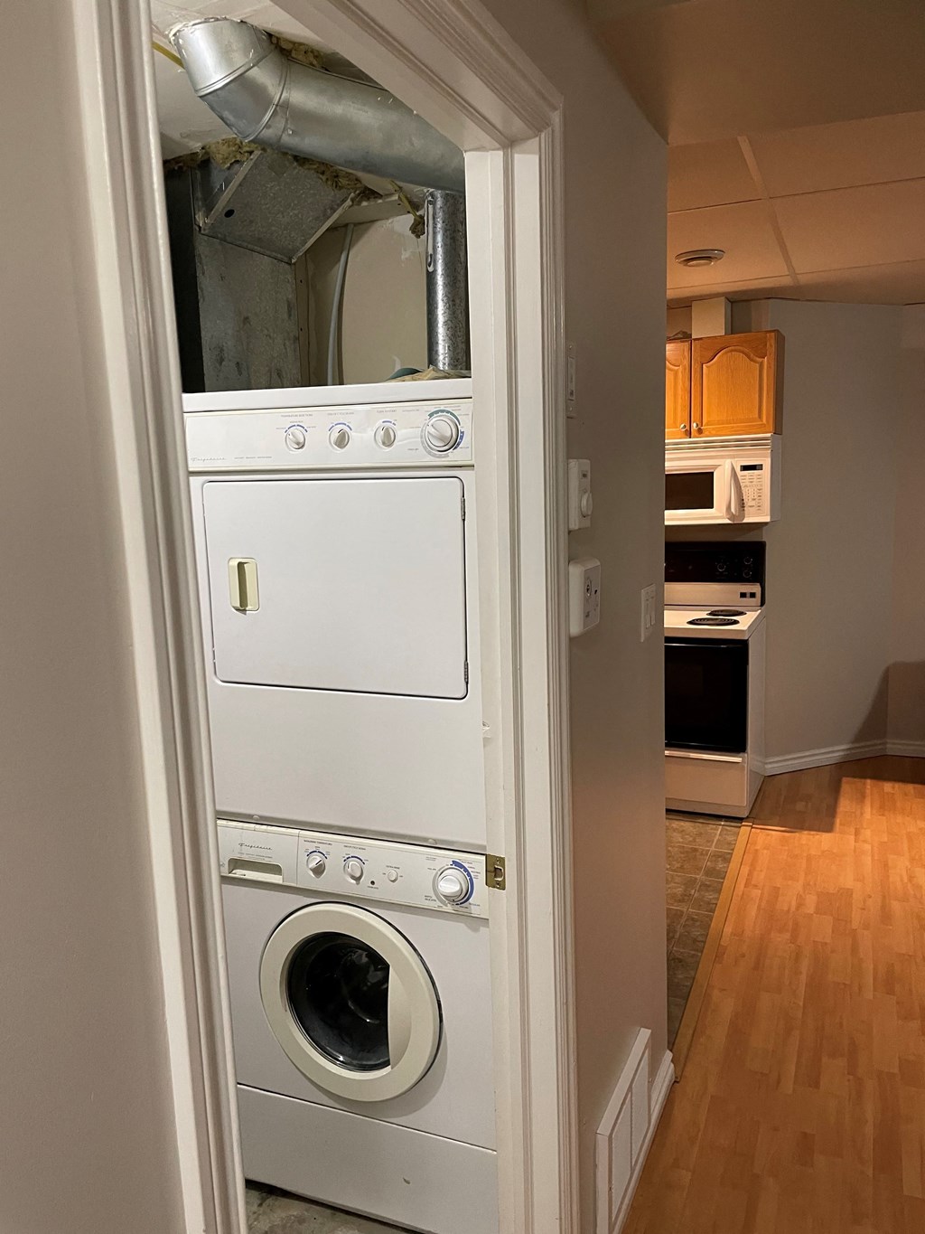 a front loading washer and dryer in a kitchen doorway