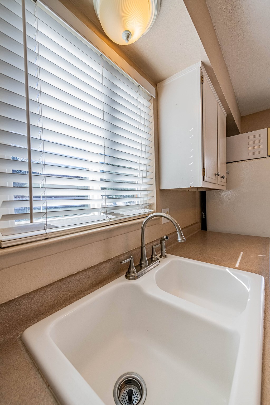 a kitchen with a sink and a window