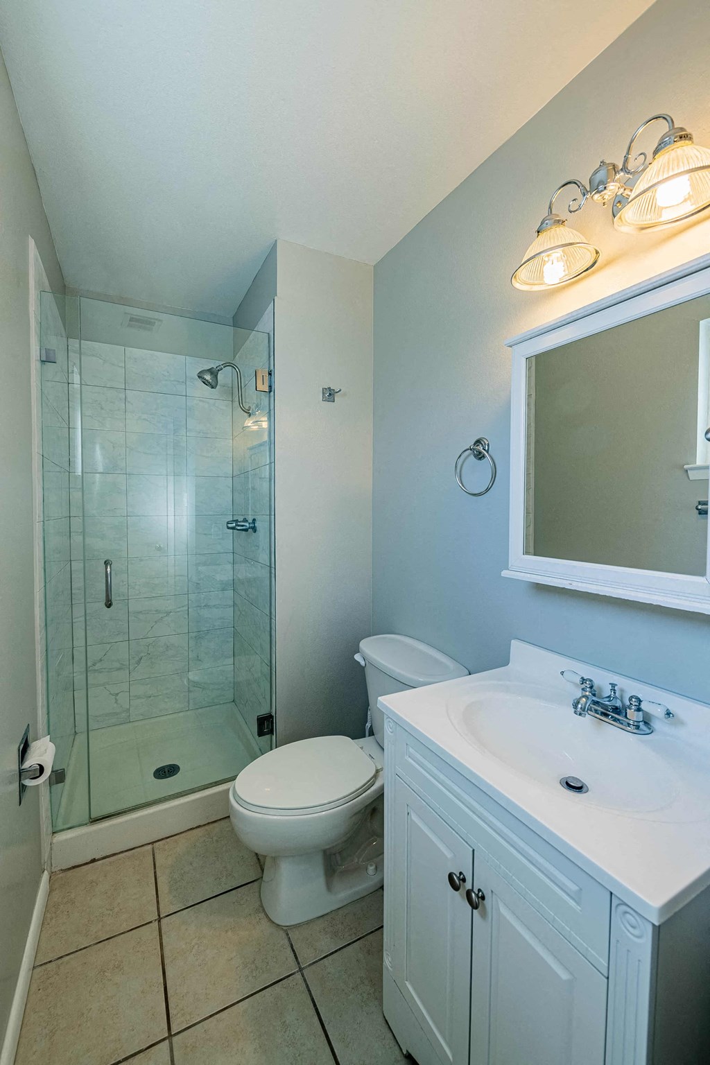 a bathroom with a shower toilet and a sink