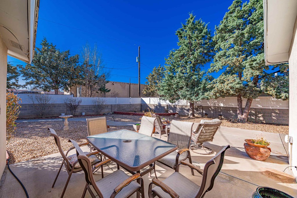 a patio with a table and chairs on it