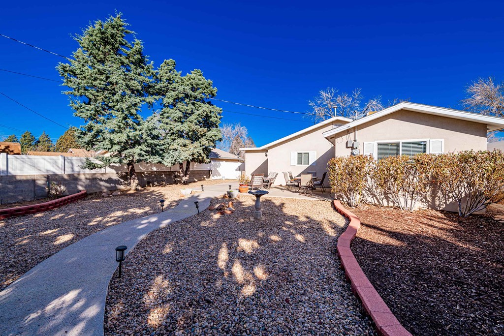 a home with a driveway and a house next to it