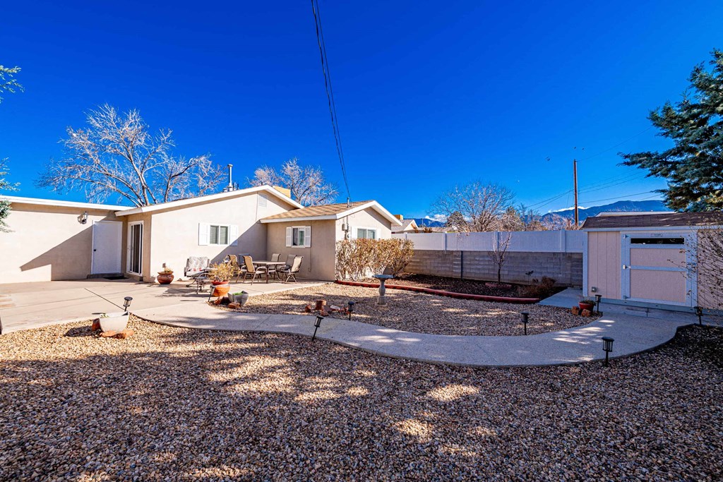 an empty yard with a house and a yard with gravel