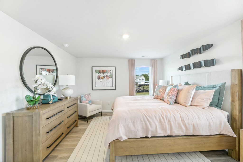 a bedroom with a bed and a dresser and a mirror