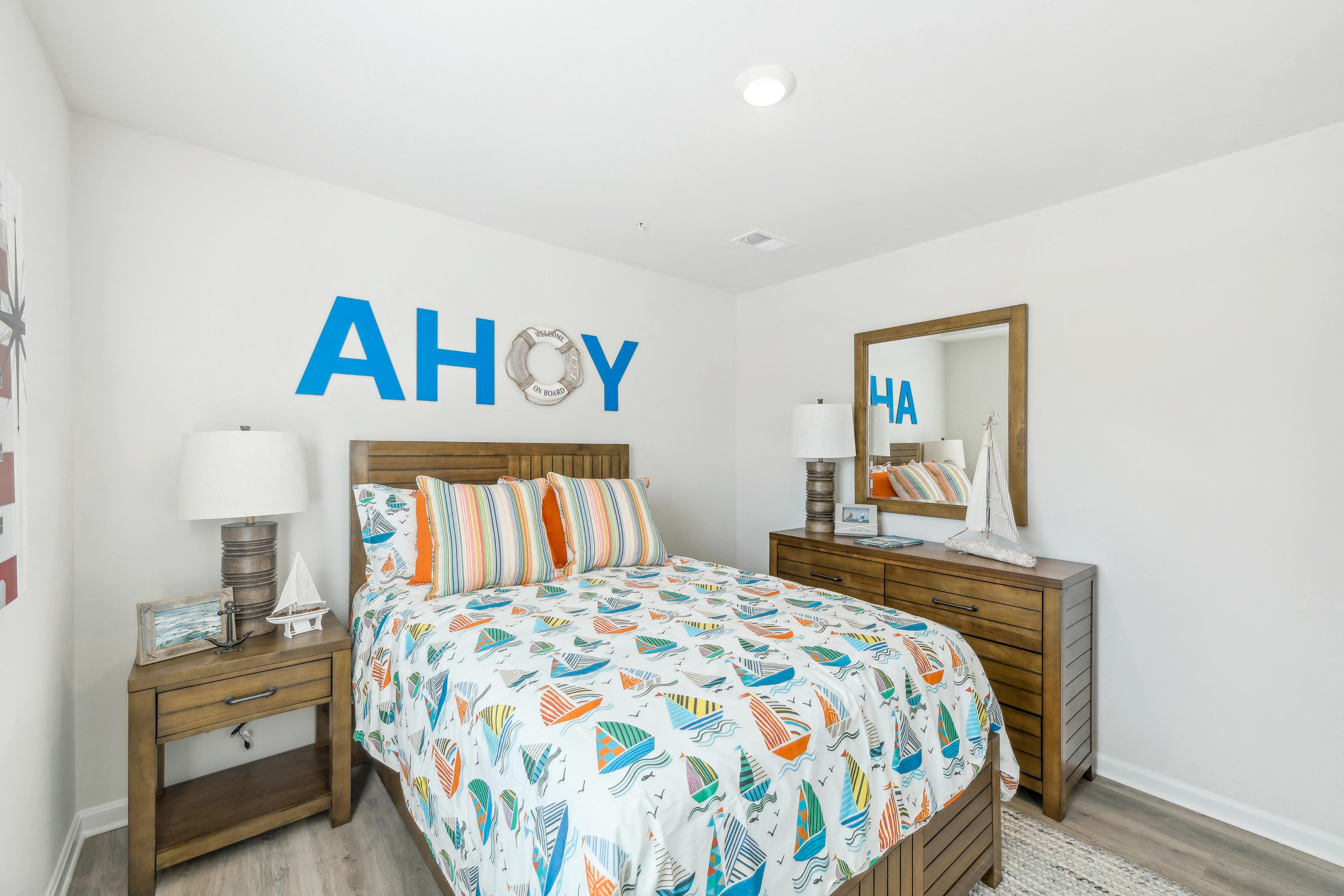 a bedroom with a bed with a colorful comforter and two night stands