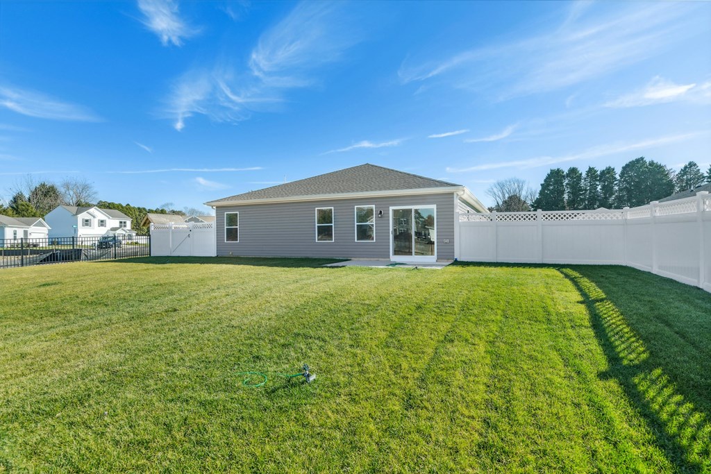 a backyard with a fence and a house