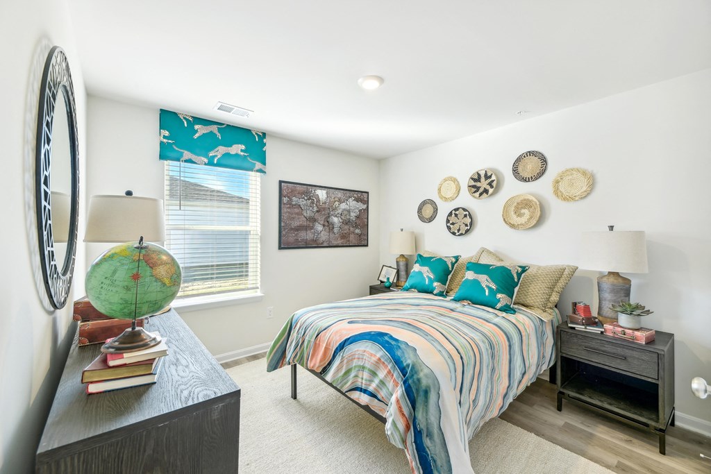 a bedroom with a bed and a dresser and a window