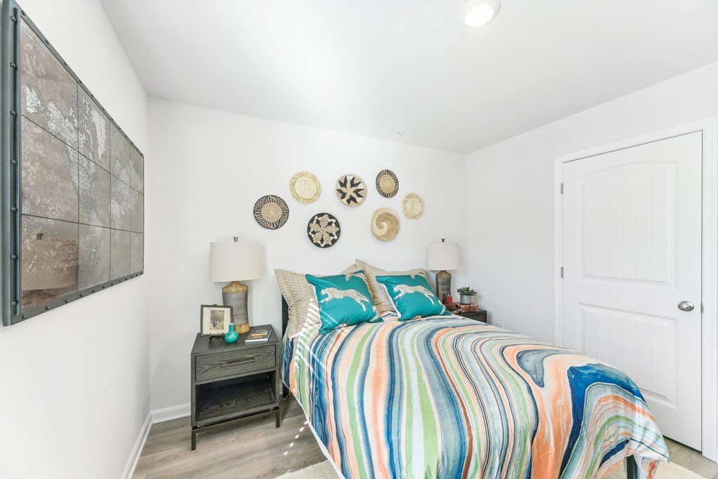 a bedroom with a bed and a painting on the wall