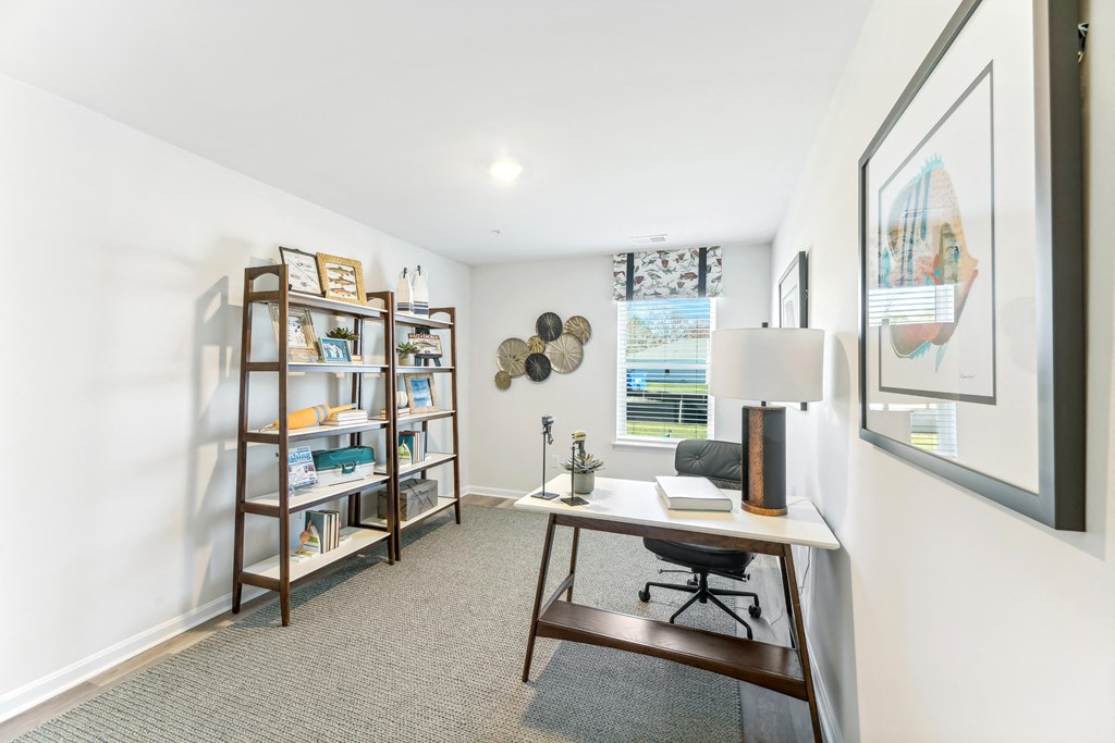 a home office with a desk and a window