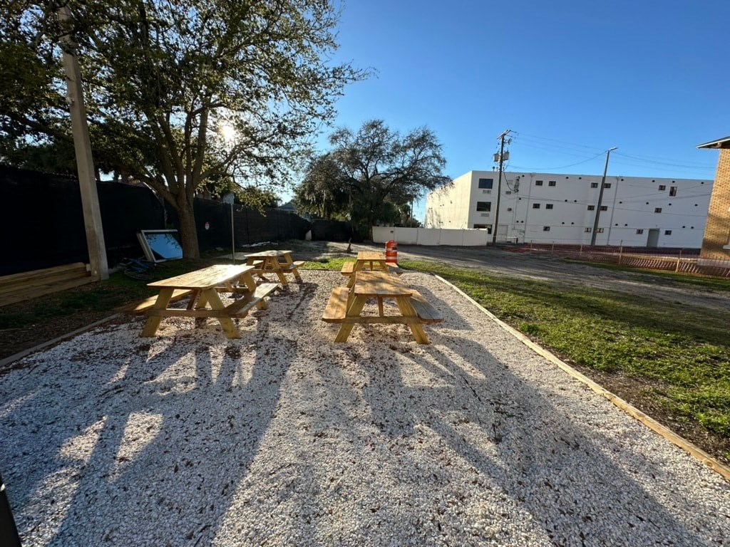 a picnic area with two benches and a fire hydrant