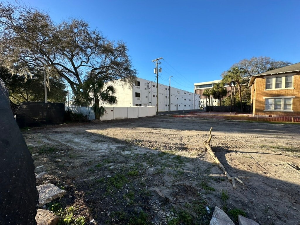 a dirt road with a building in the background