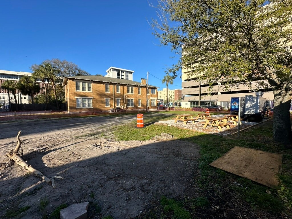 a construction site on the corner of a street in front of a building