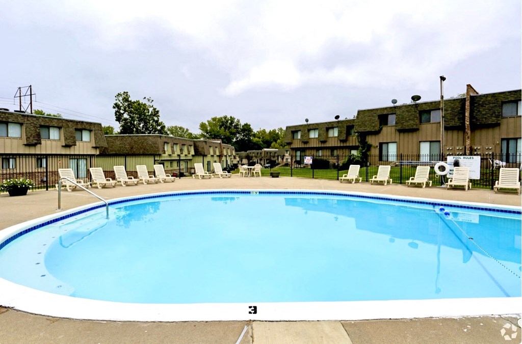 a swimming pool is shown in front of a hotel pool