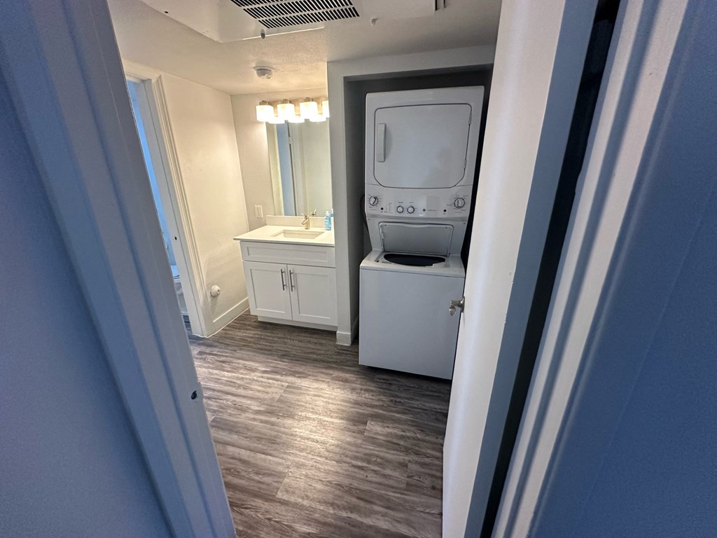 a door view of a bathroom with a washer and dryer