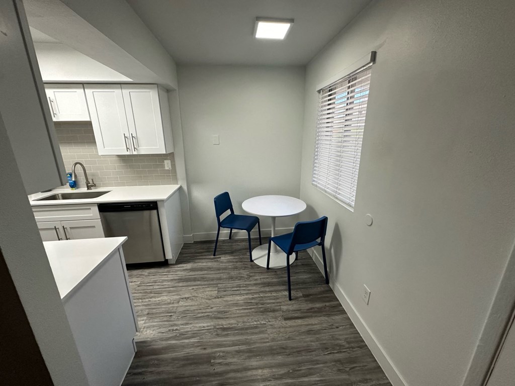 a kitchen and dining area with a table and chairs