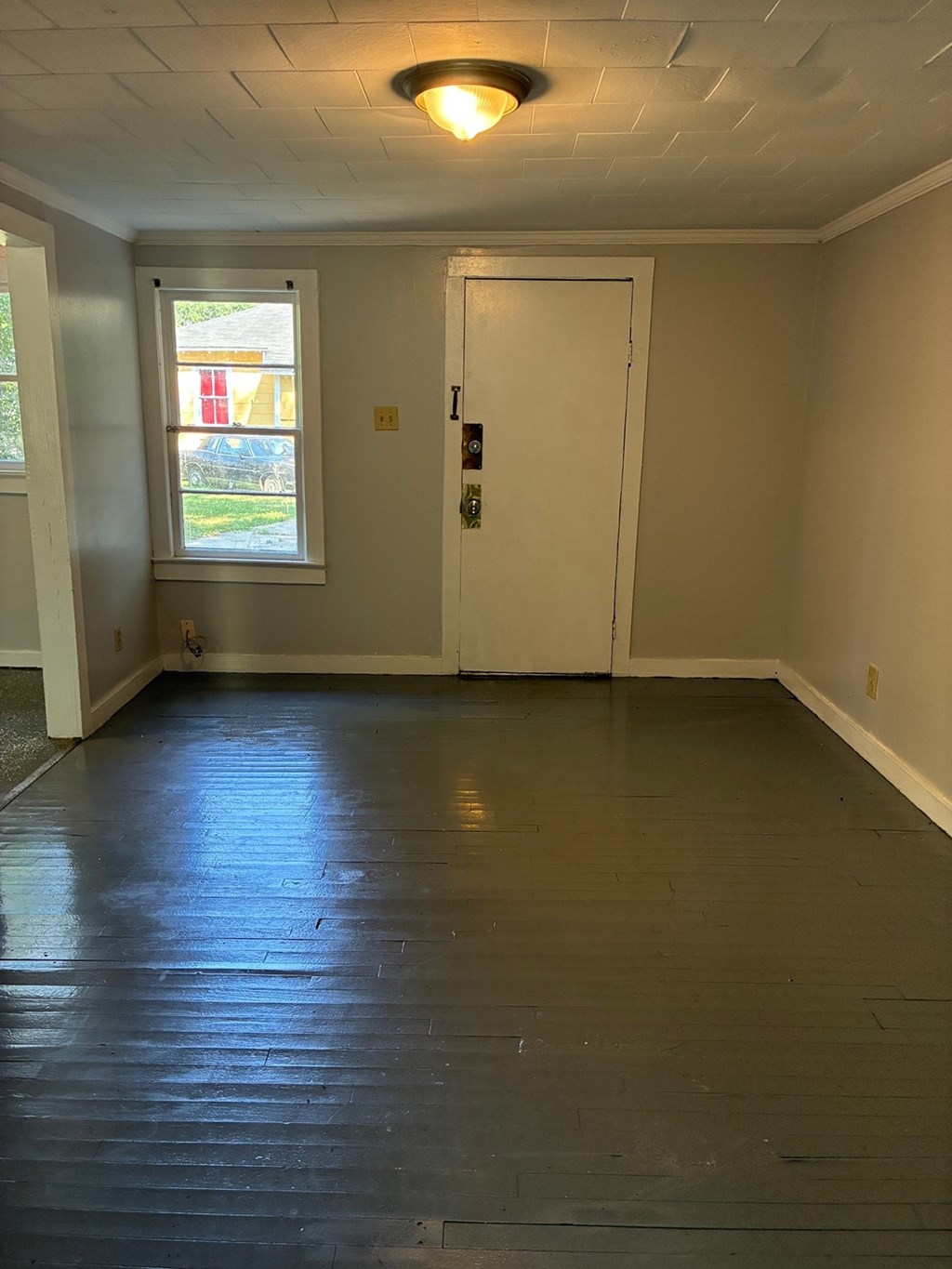 A room with a white door and a window.