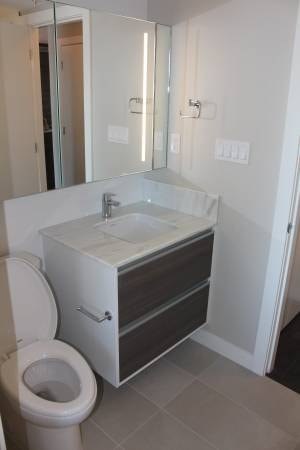 A white toilet with a sink and drawers underneath it.