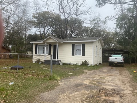a small house with a white truck parked outside of it