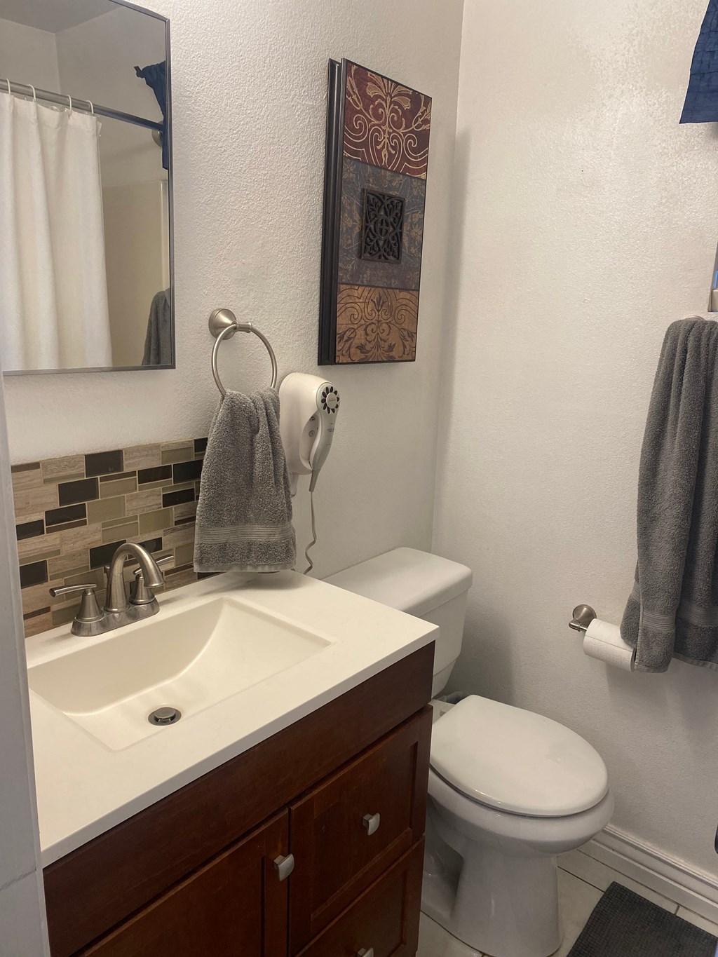a bathroom with a sink and a toilet and a mirror