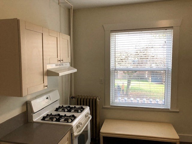 a small kitchen with a stove and a window