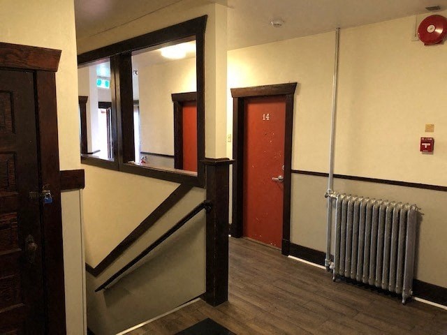 a hallway with a radiator and a mirror